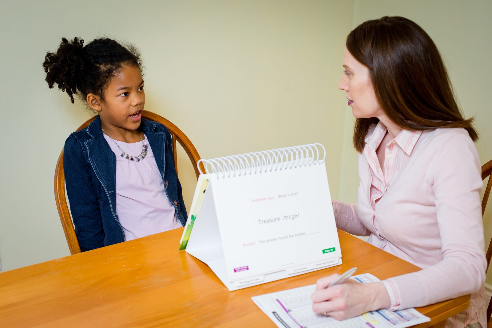 Cynthia completing a play-based speech assessment with a child
